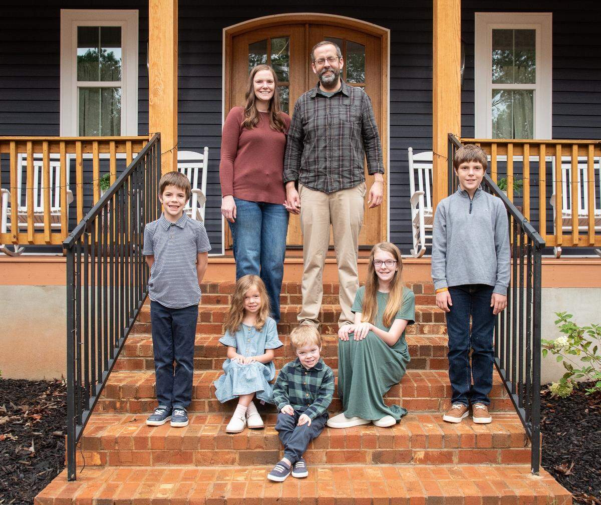 Shane Gottwals, owner of Gottwals Books and Houston County Commissioner, smiles for a photo with his family at their home in Warner Robins.