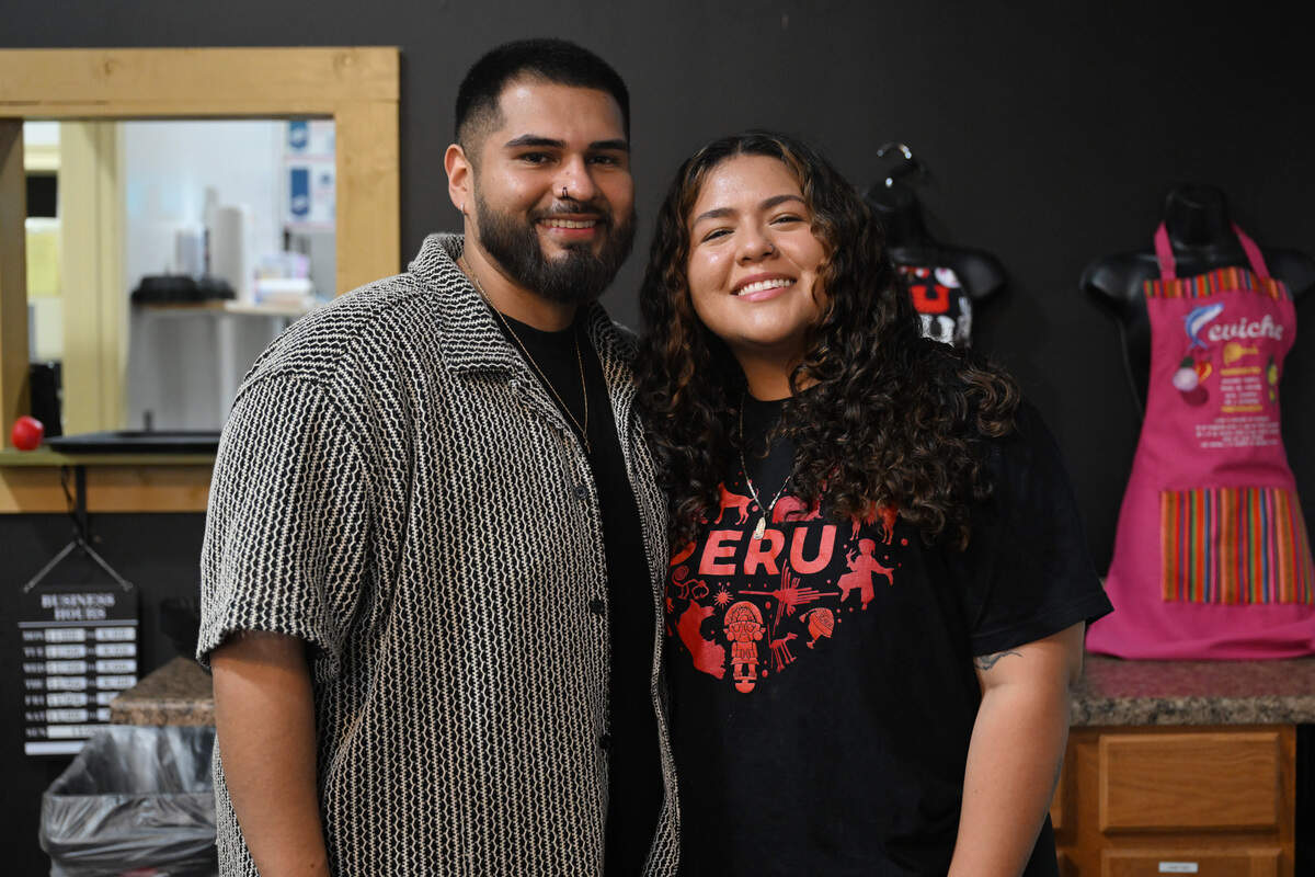 Asu Mare Peruvian Restaurant owners Jonathan "Jay" Molina (left) and Jessy Paredes pose behind the counter of their restaurant in Centerville, Ga.