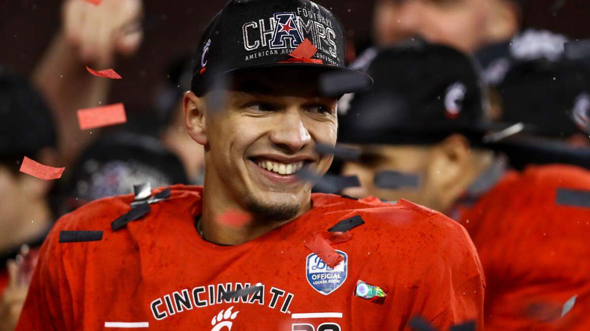 Cincinnati quarterback Desmond Ridder reacts on the field following the American Athletic Conference championship NCAA college football game against Tulsa, Saturday, Dec. 19, 2020, in Cincinnati. Cincinnati won 27-24. (AP Photo/Aaron Doster)