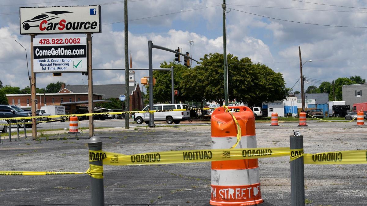 The sign for CarSource sits off of Watson Boulevard with caution tape around it on Thursday, May 23, 2024, in Warner Robbins, Georgia. The CarSource building was the third building demolished as a part of Warner Robbins’ Operation Reawaken to revitalize around Commercial Circle.