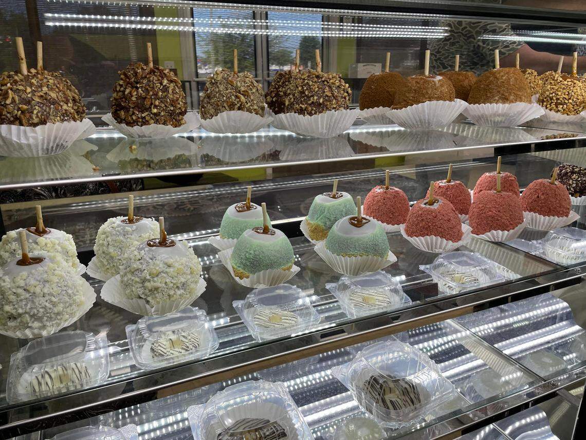 A view of some of the choices of gourmet caramel apples from behind the counter at The Apple Basket in Centerville at the reopening of the popular shop on Monday, May 5, 2025.