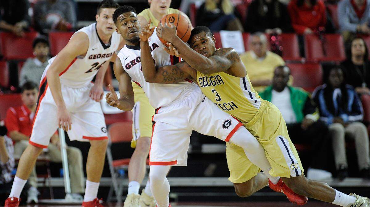 Georgia guard Kenny Gaines (12) and Georgia Tech guard Marcus Georges-Hunt (3) fight for a loose ball during the first half of Saturday's game.