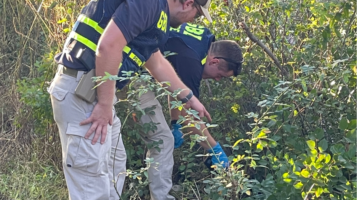 GBI officers investigate the scene after a Peach County deputy shot a Warner Robins man in Fort Valley following a brief chase Tuesday afternoon.