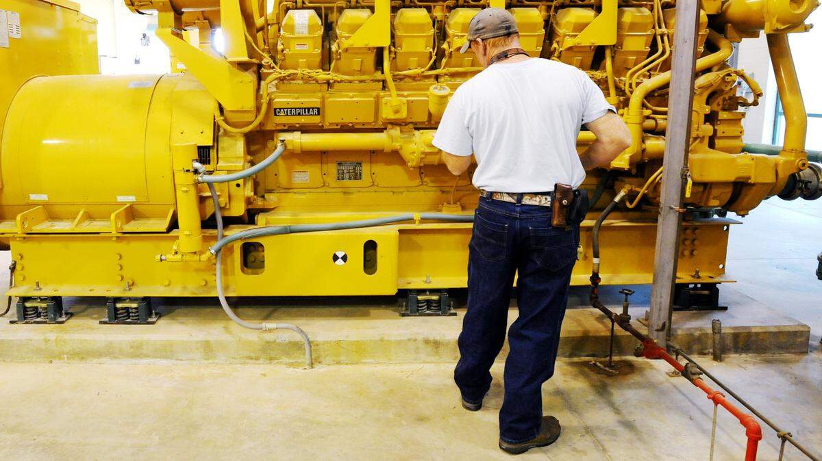 In this 2012 photo, Macon Water Authority maintenance mechanic Bert Rozier checks the oil level in one of the authority’s pump generators.