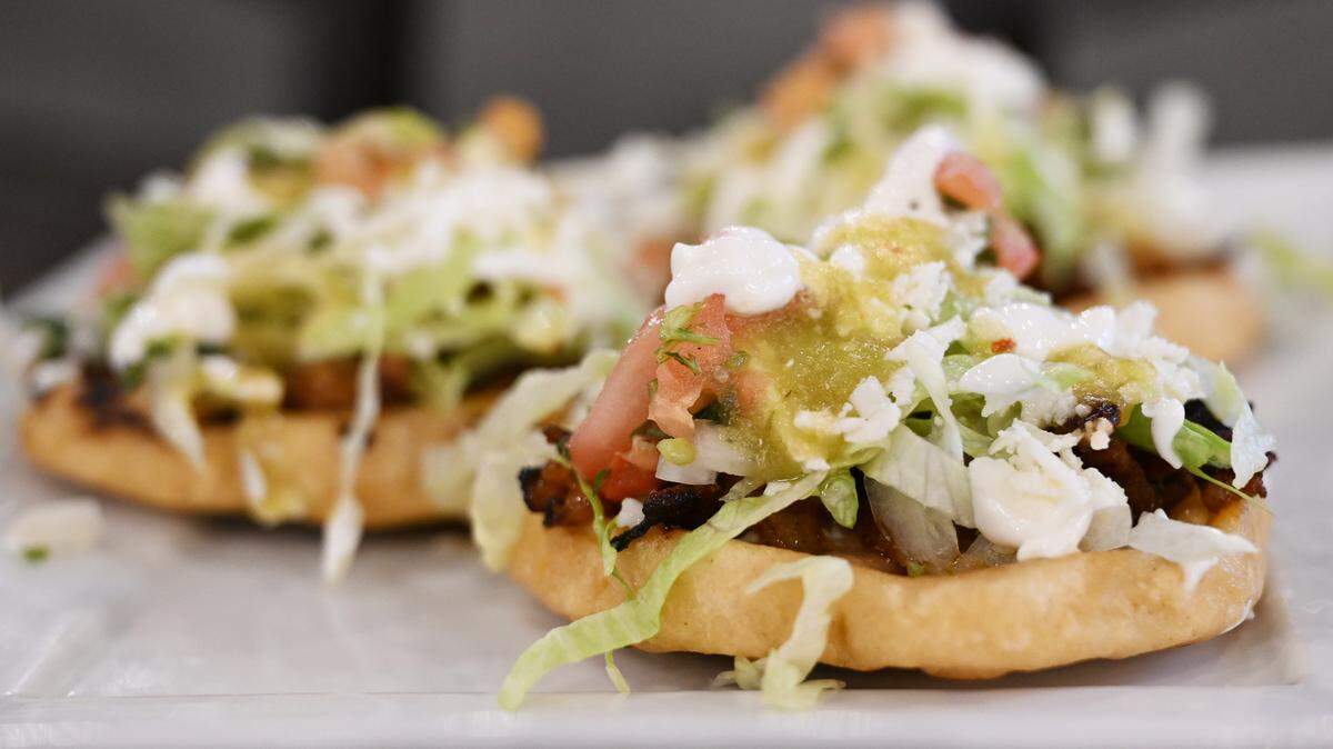 Three deep fried sopes on a plate inside of Fuego Fresco Mexican Restaurant on Thursday, Aug. 28, 2025, in Perry, Georgia. The sopes are topped with beans, meat, lettuce, sour cream, pico de gallo and cheese.