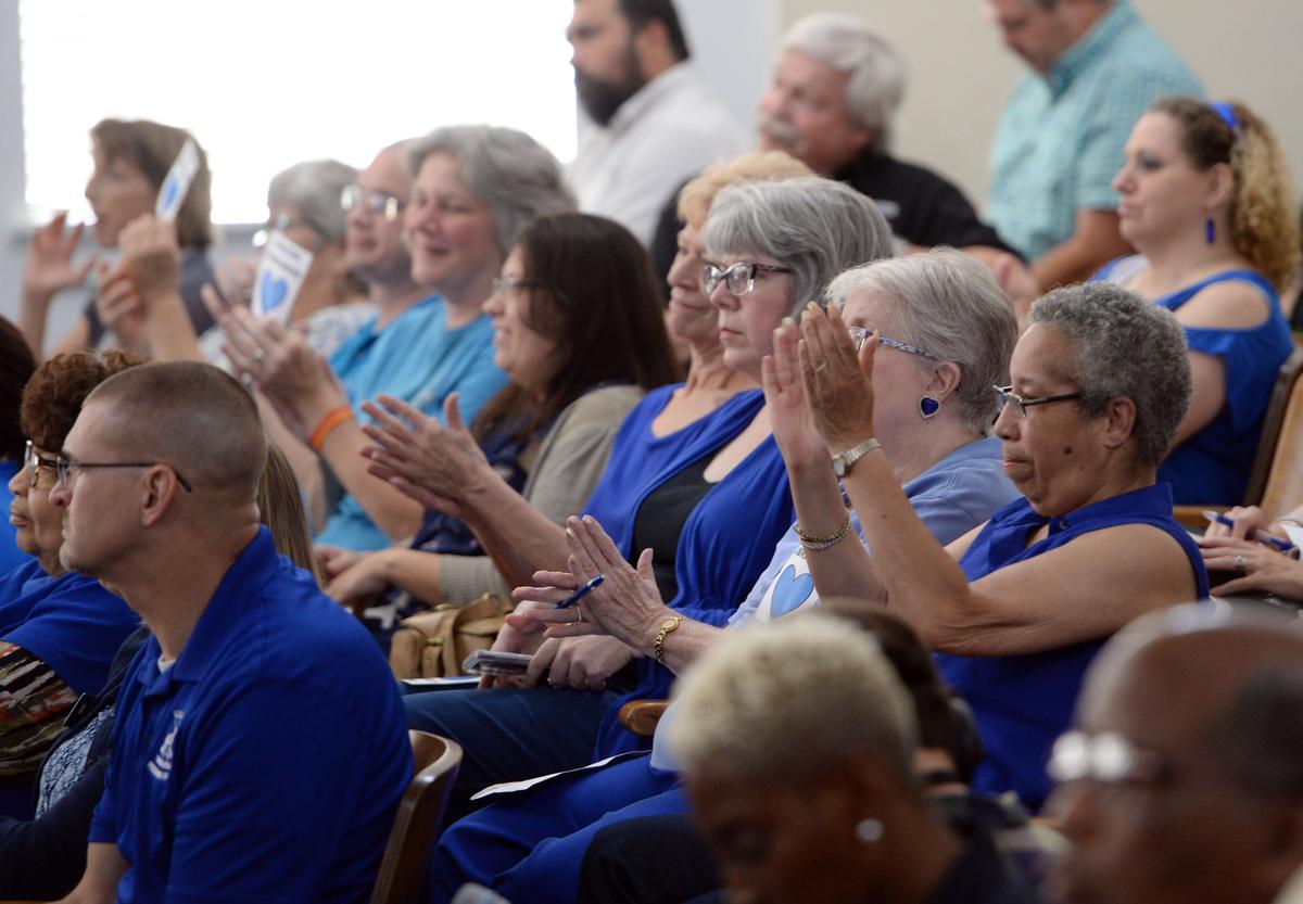 Library employees and supporters react to the Macon-Bibb County Commission passing funding that would enable the system to resume normal services by Aug. 27. In addition to the emergency measure, commissioners passed a millage rate of 20.652, 3 mils higher than last year.