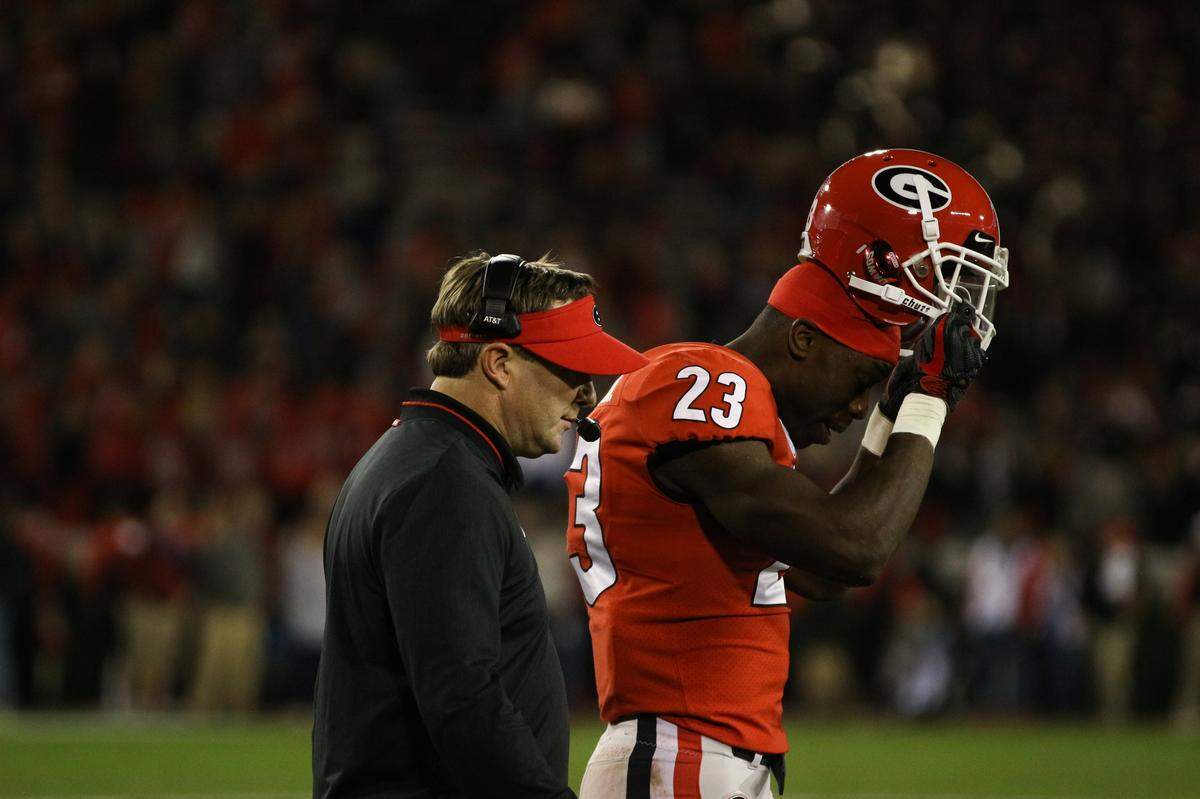 Georgia head coach Kirby Smart talks to Georgia defensive back Mark Webb (23) during an NCAA football game between the University of Georgia and the University of Massachusetts in Sanford Stadium in Athens, Ga., on Saturday, Nov. 17, 2018.
