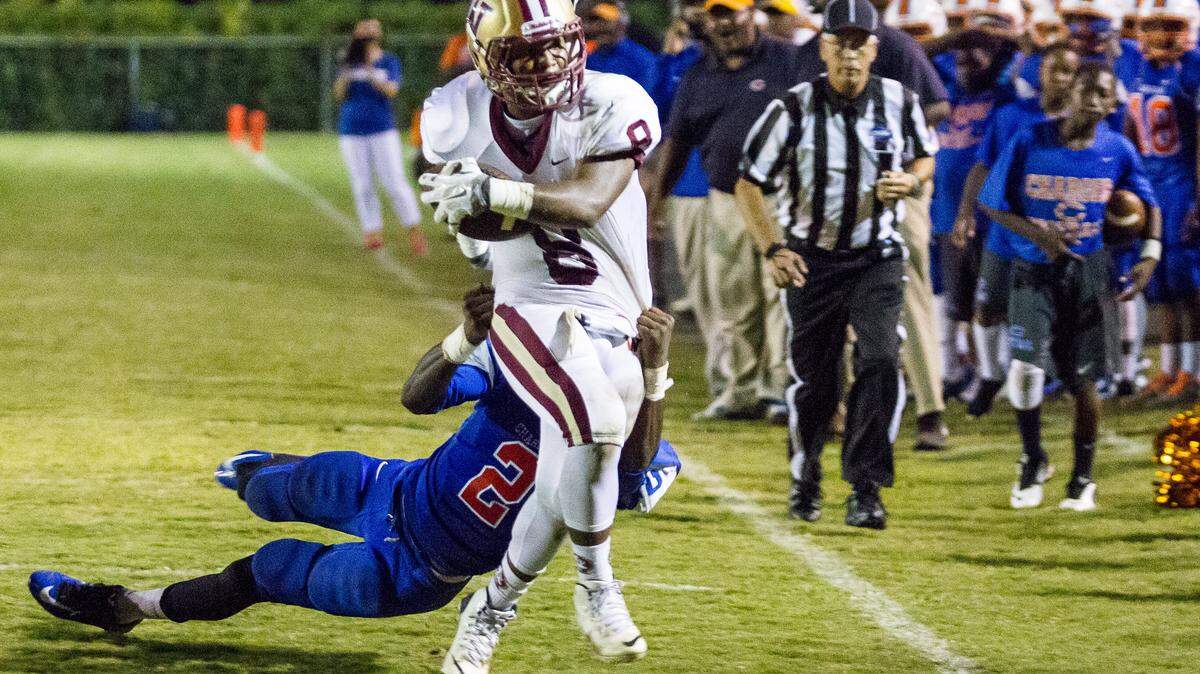 Westside’s Nygel Woodard being tackled by Central’s Jeremy Denson after a long gain in the 1st half of their 2-AAA matchup.