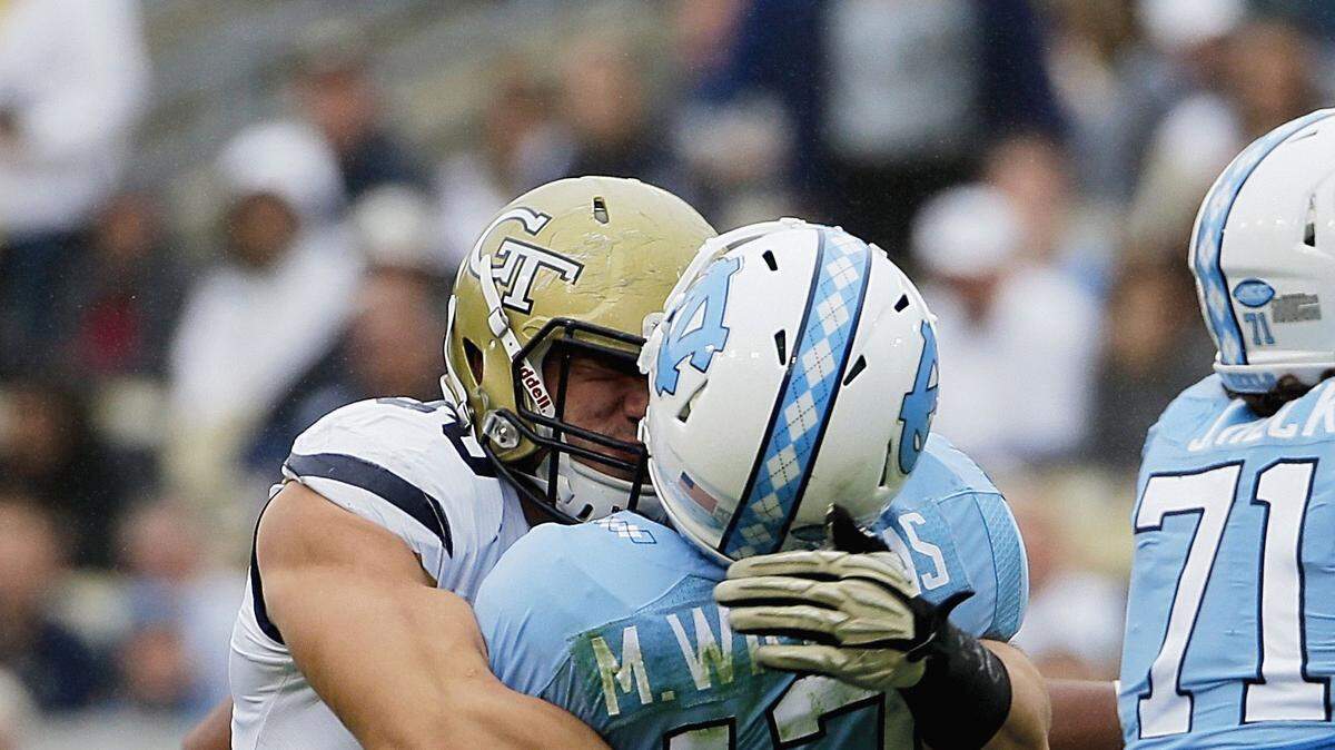 Georgia Tech defensive lineman Adam Gotsis, left, sacks North Carolina quarterback Marquise Williams in the second quarter of an NCAA college football game Saturday, Oct. 3, 2015, in Atlanta. Gotsis was ejected from the game for the hit. (AP Photo/David Goldman)