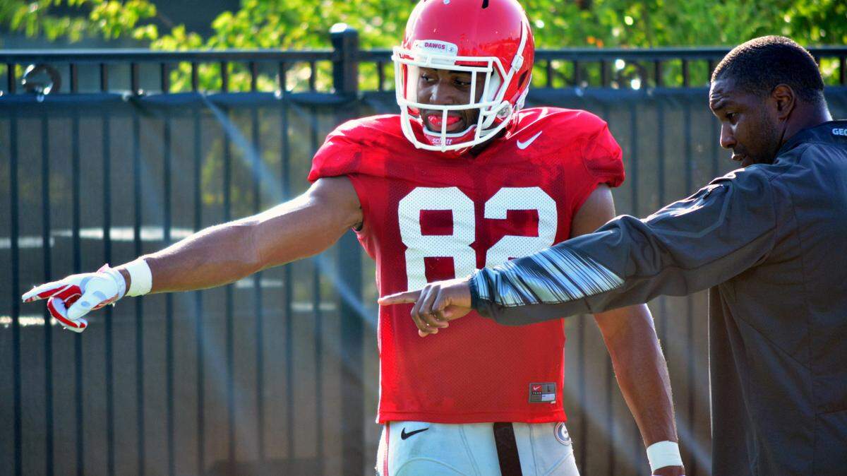 Georgia receiver Michael Chigbu (82) and assistant coach Bryan McClendon go through discussions during a recent preseason practice.