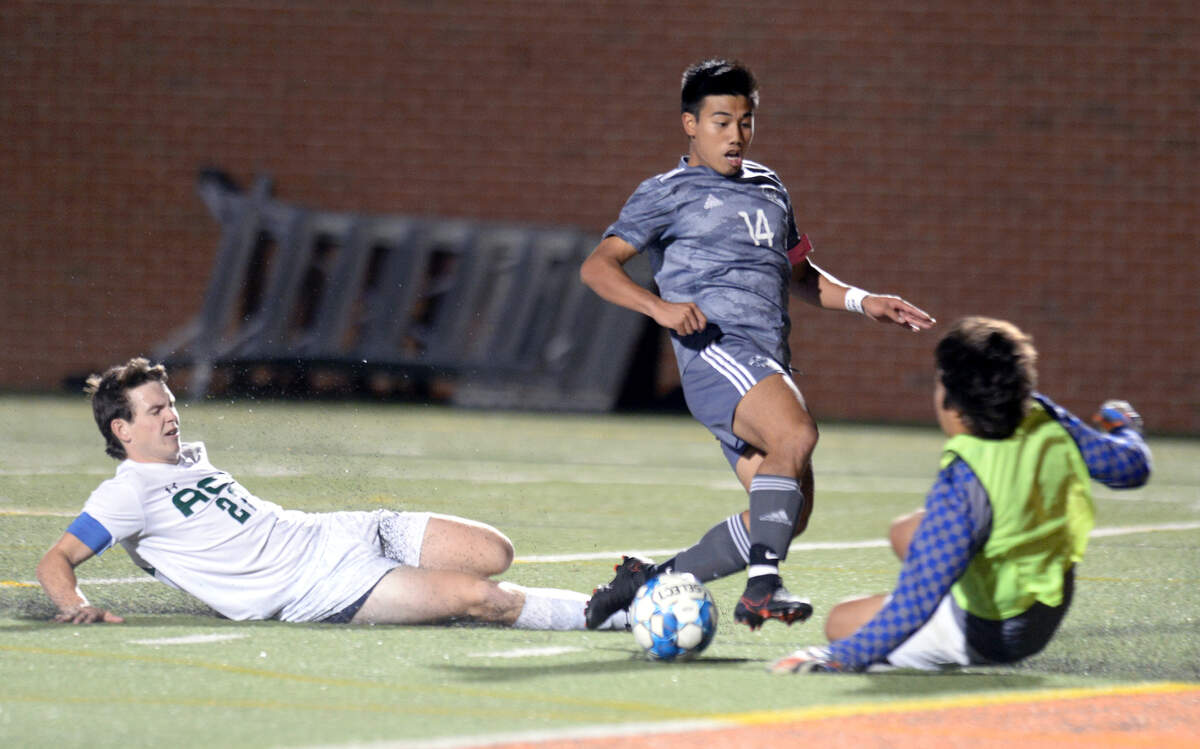 GMC striker Ethan Tolentino (14) attempts to score on ACE goalie Tate Turner (1) during the GHSA 1A State Championship Friday night at Mercer.