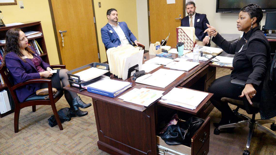 Westside Principal Julia Daniely, right, speaks with, from left, Frances Davis, Robert Betzel and Todd Hunt in her office on Jan. 11. More than 50 community members participated Thursday in the Bibb County school district's Principal for a Day. Daniely is in a finalist for the state's Principal of the Year.