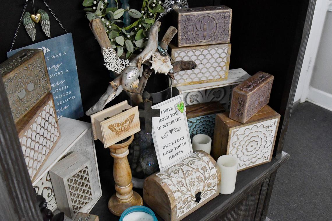 A number of hand carved boxes sit on a shelf on Thursday, June 6, 2024, at Petamorphosis in Macon, Georgia. All of these are options for packaging a pet’s ashes after the aquamation process performed at Petamorphosis.