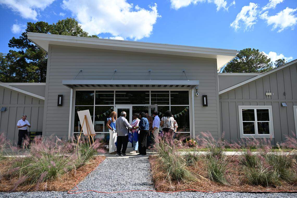 Ceremony attendees stand in the native plant garden outside of the Cathy Ivey Community Library on Monday, Oct. 13, 2025, in Macon, Georgia. The new library includes a community garden area that highlights native plants. 