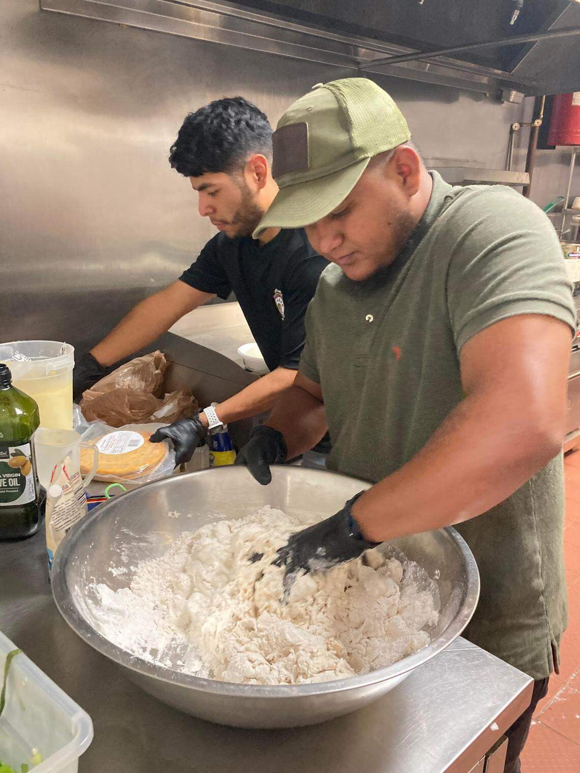 Co-owner Eduardo Barcenas and cook Gustavo Villafran prepare food at Sabor Latino Venezuelan Restaurant, a new spot in Warner Robins serving authentic Venezuelan cuisine.