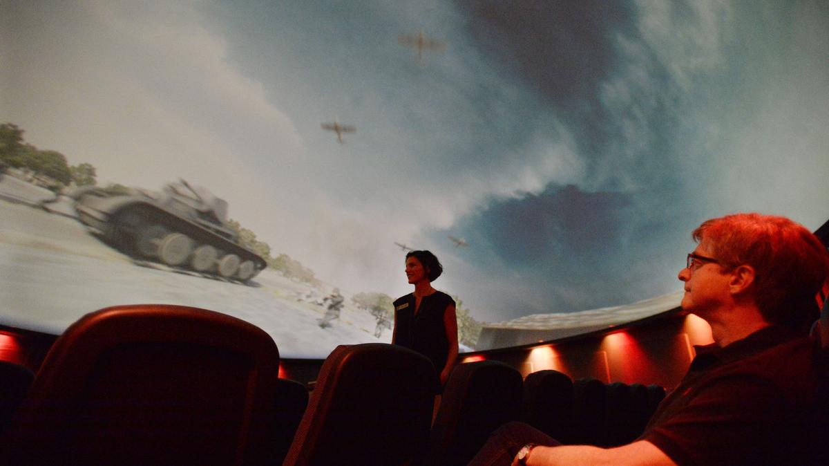 Museum of Arts and Sciences Executive Director Susan Welsh, center, and science curator Paul Fisher, right, preview “World 2 War,” one of the full-dome motion pictures that will be shown during the Macon Film Festival this weekend.