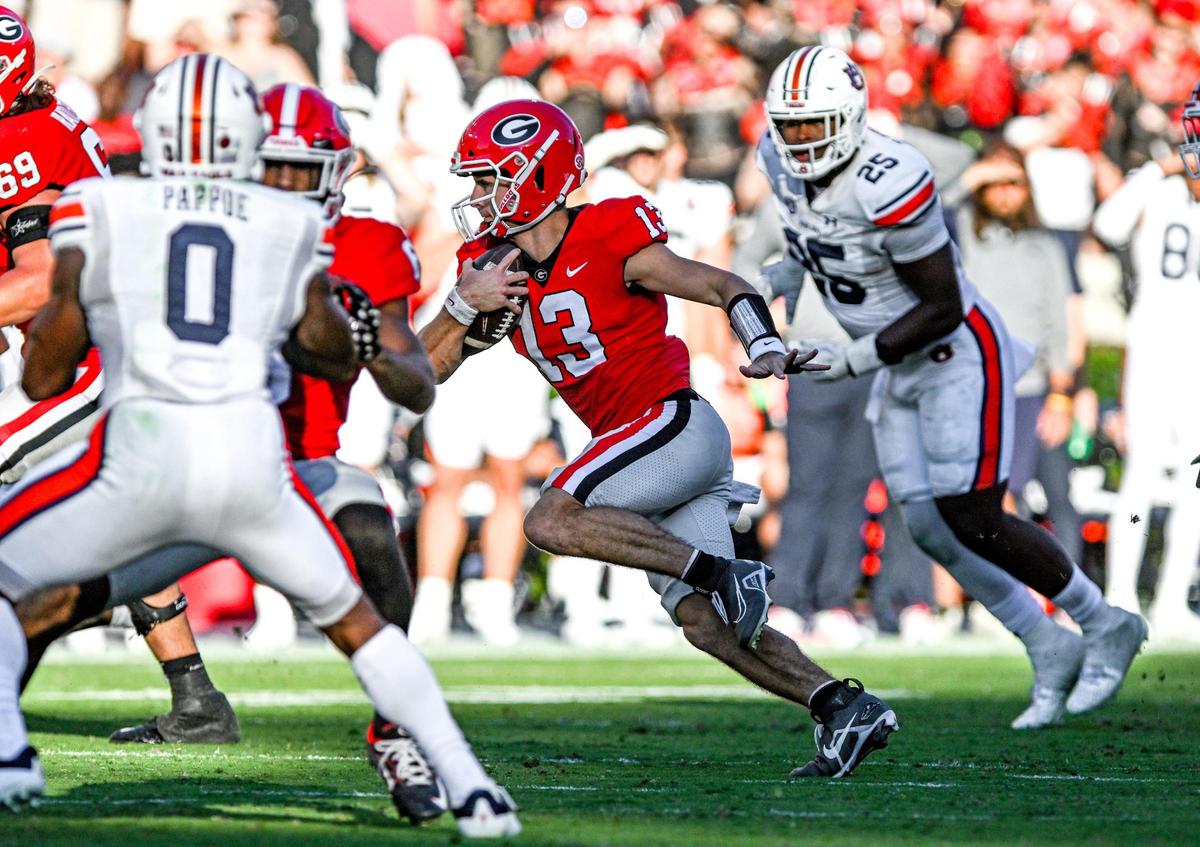 Georgia quarterback Stetson Bennett finds room up the middle and heads for a first down against Auburn Saturday in Athens.