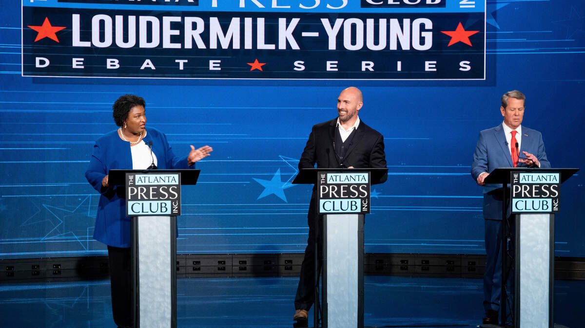 Democratic challenger Stacey Abrams, from left, Libertarian challenger Shane Hazel and Georgia Republican Gov. Brian Kemp debate during the Atlanta Press Club Loudermilk-Young Debate Series in Atlanta, Monday, Oct. 17, 2022. (AP Photo/Ben Gray)