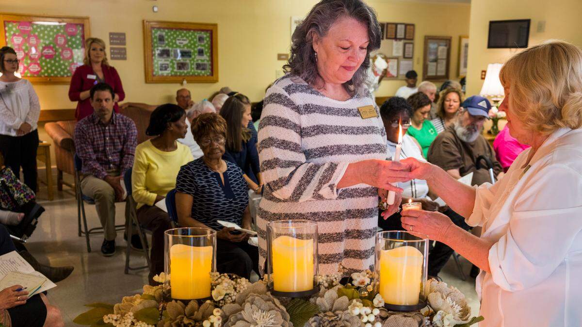 Staff members of the Gray Health & Rehabilitation assisted living home participate in the annual bereavement ceremony there when family members of deceased residents do not attend.