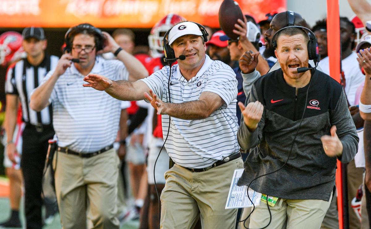 Coach Kirby Smart motions to his players Saturday as the Dawgs beat Auburn 42-10.