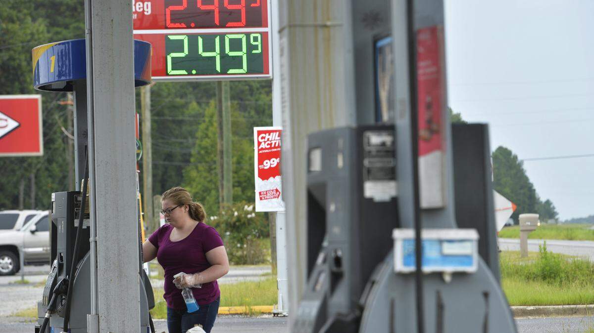 Madison Fabry cleans the pumps at Ohri's store along Gray Highway just north of the Bibb County line where owner Benny Ohri said customers don't have to wait in line for gas. "Even though Sunoco is one of the best, people with drive up the road for one cent,'' he said.