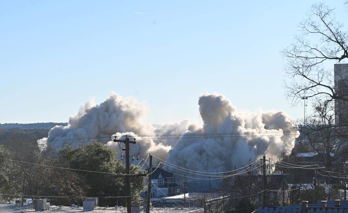 Clouds of smoke wafted through downtown Macon, Ga. when a building known as the old Ramada Hotel imploded at 9 a.m. on New Year’s Day of 2025 on First Street and Riverside Drive. This is a view from Coleman Hill Park where hundreds of people gathered to witness the demolition.