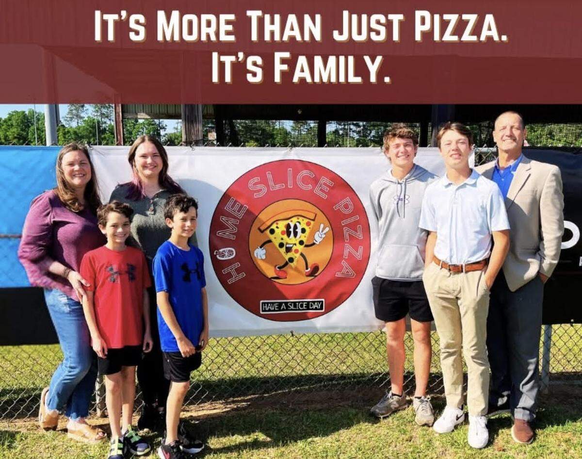 LeAnn, far left, and Paul Register, far right, owners of Home Slice Pizza in downtown Perry, with their family, from left to right, Haley, 17, twins Colton and William, 11, Bryson, 16, and Ryles, 14. Grayson, 9, and Ellie, 6, are not pictured.