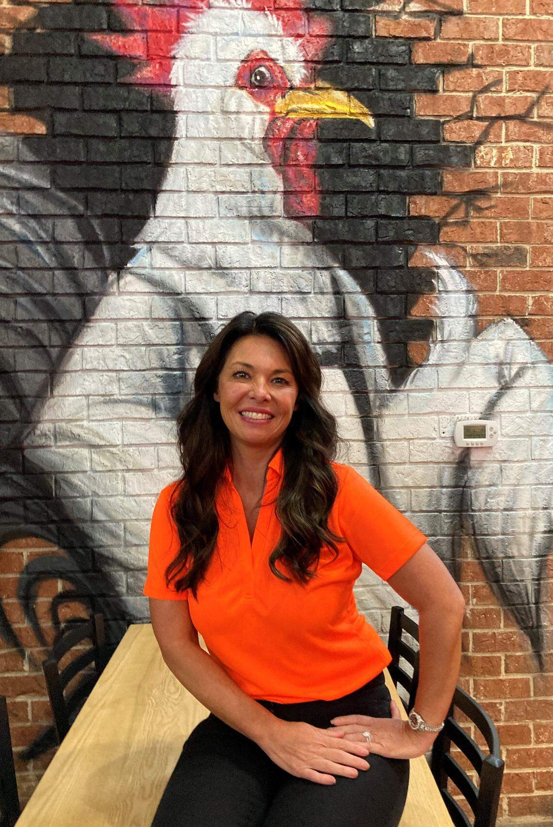 Cathy Reece, co-owner of the The Hot Chik in Warner Robins. The new restaurant features the work of artist Kevin “Scene” Lewis.