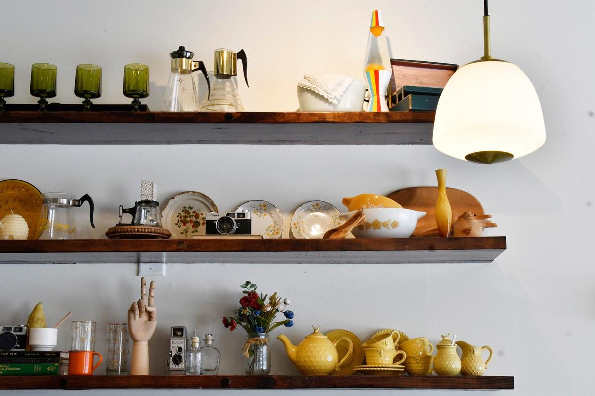 Shelves of collectibles hang inside of Oh Honey Baking Co. on Thursday, May 23, 2024, in Macon, Georgia.