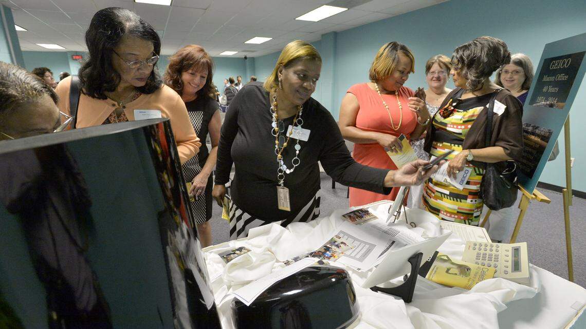 Longtime Geico employees check out the contents of a time capsule the company planned to bury for their 40th anniversary in Macon in 2014.