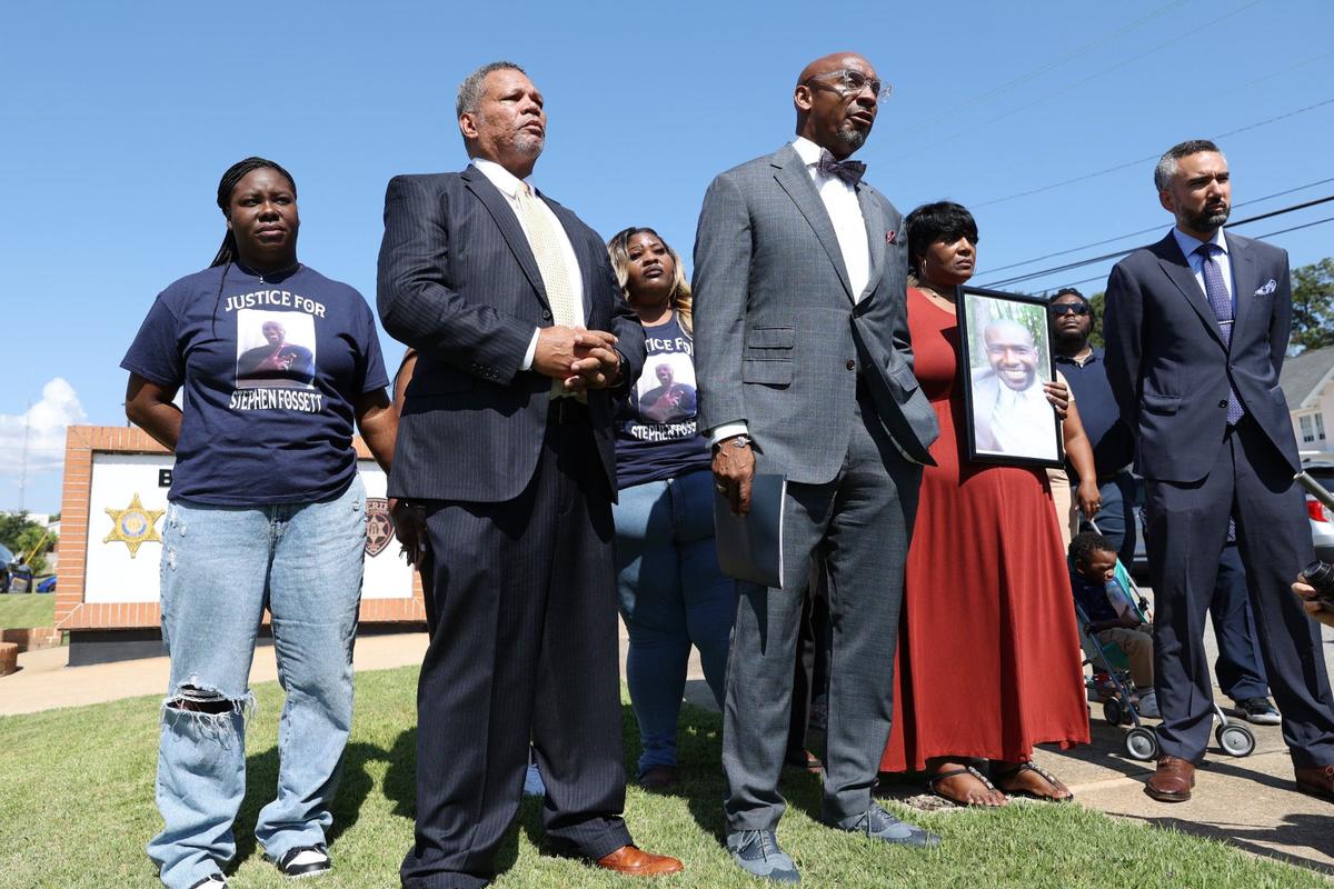 Attorneys from Davis Bozeman Law and The Fitzpatrick Firm, LLC stand with family members of Stephen Fossett during a press conference outside of the Bibb County Jail on Tuesday, Aug. 28, 2024, in Macon, Georgia. Fossett died in late May while in custody at the Bibb County Jail after experiencing a medical emergency and subsequent tasing. Now, his family have launched an investigation into circumstances of his death.