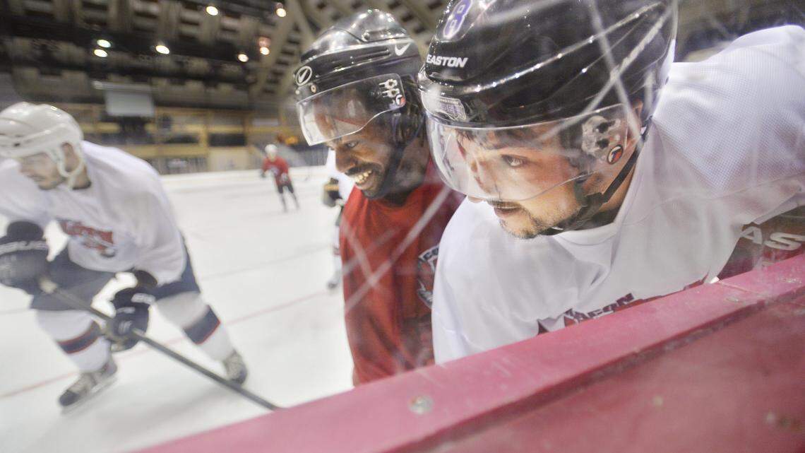 Mayhem players pile into the boards at the Macon Coliseum during a practice to see who will make the team.
