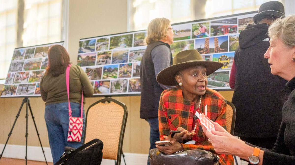 Angel Irving, second from right, talks with Atlanta landscape architect and planner Lauren Standish, right, during a community meeting about the proposed East Bank redevelopment project at the old Bibb Mill site. Irving said as the project goes forward, she wants assurances that on site jobs are open to local workers.