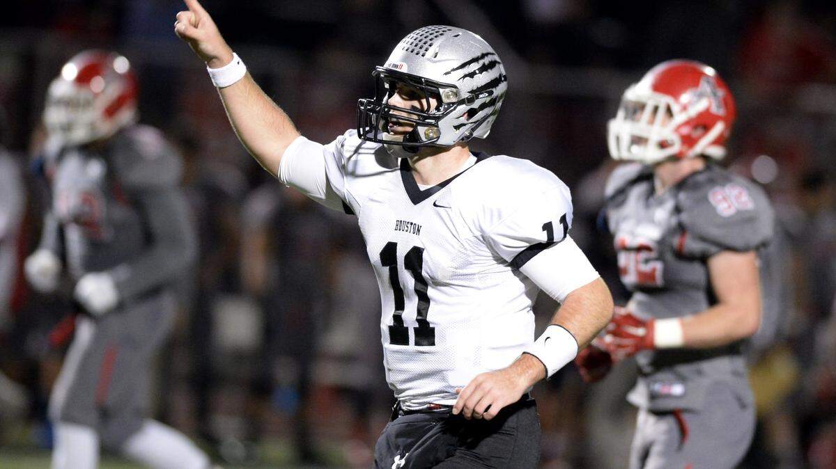 JASON VORHEES/THE TELEGRAPH Macon, GA, 1 1/27/2015:.Houston County quarterback Jake Fromm (11) puts a finger in the air after connecting with wide receiver Eli Watson (14) for a touchdown at the end of the first half of their game against Allatoona Friday night.