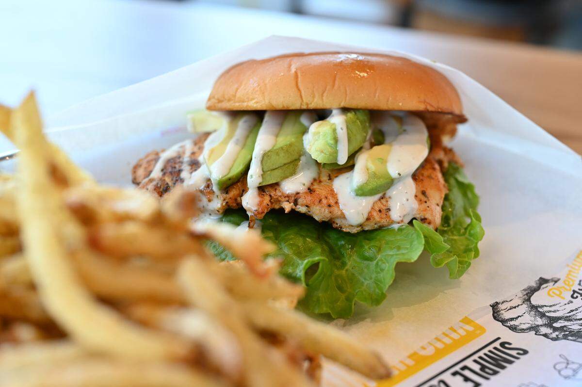 Bacavo Ranch sandwich served with fries sits inside Super Chix Chicken & Custard on Thursday, Oct. 2, 2025, in Macon, Georgia. The sandwich features chicken, bacon, sliced avocado, lettuce, tomato and topped with ranch.