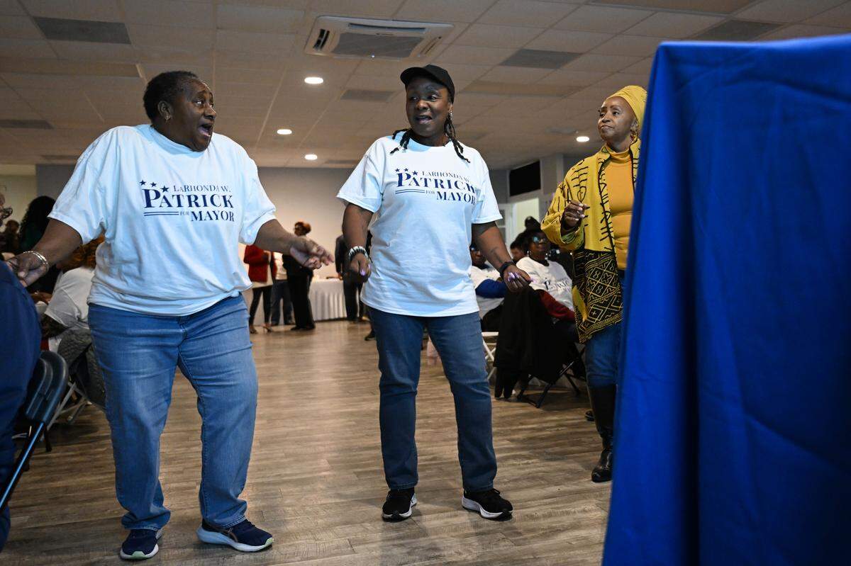 Theodora Springle (far left), Antuanette Davis (middle) and Sharon Ellis dance at an election results watch party for incumbent Warner Robins Mayor LaRhonda Patrick on Tuesday, Nov. 4, 2025, at the Curtis Event Center in Warner Robins, Georgia.