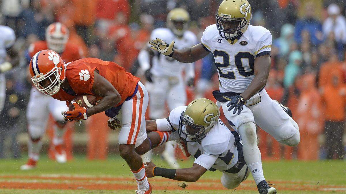 RICHARD SHIRO/ASSOCIATED PRESSClemson’s Germone Hopper, left, slips the tackle attempt of Georgia Tech’s Corey Griffin, center, and Lamar County product Lawrence Austin (20) during the first half of Saturday’s game.