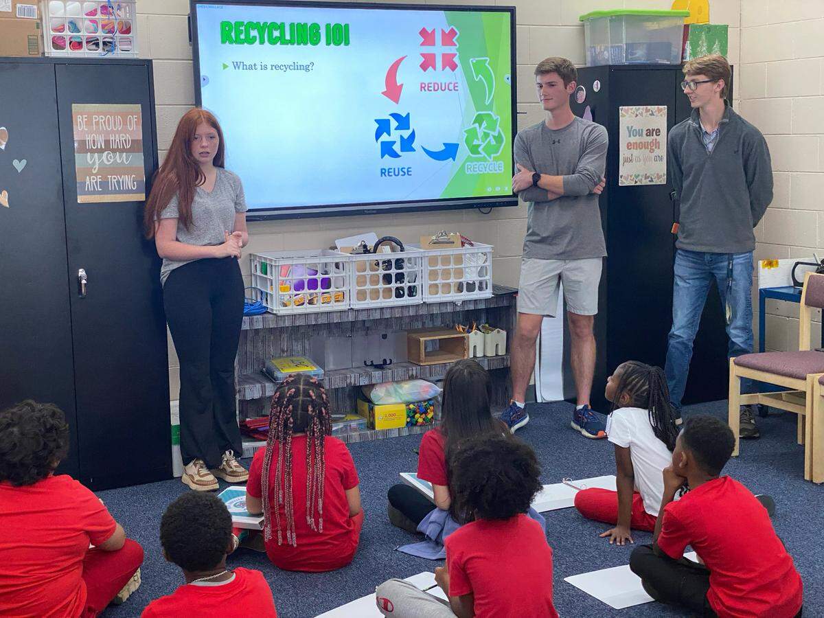 Singleton, Chun and Griner (L to R) teaching a class of Houston County elementary school kids about recycling.