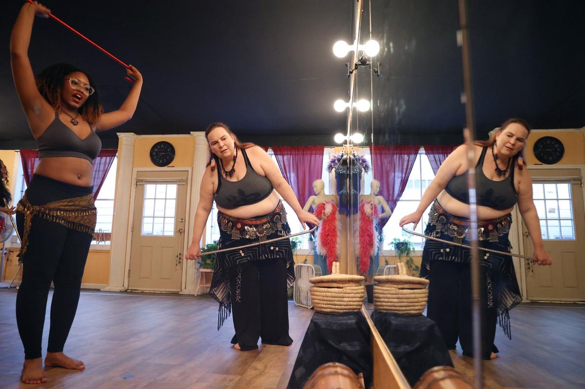 Nayahna Gordon (left) and Marie Keith-Winters review the steps of their routine written on the studio mirror during the advanced belly dancing class at Perry Belly Dance Studio on Thursday, Aug. 29, 2024, in Perry, Georgia. Perry Belly Dance Studio opened in 2010 and offers classes for all ages and skill levels.