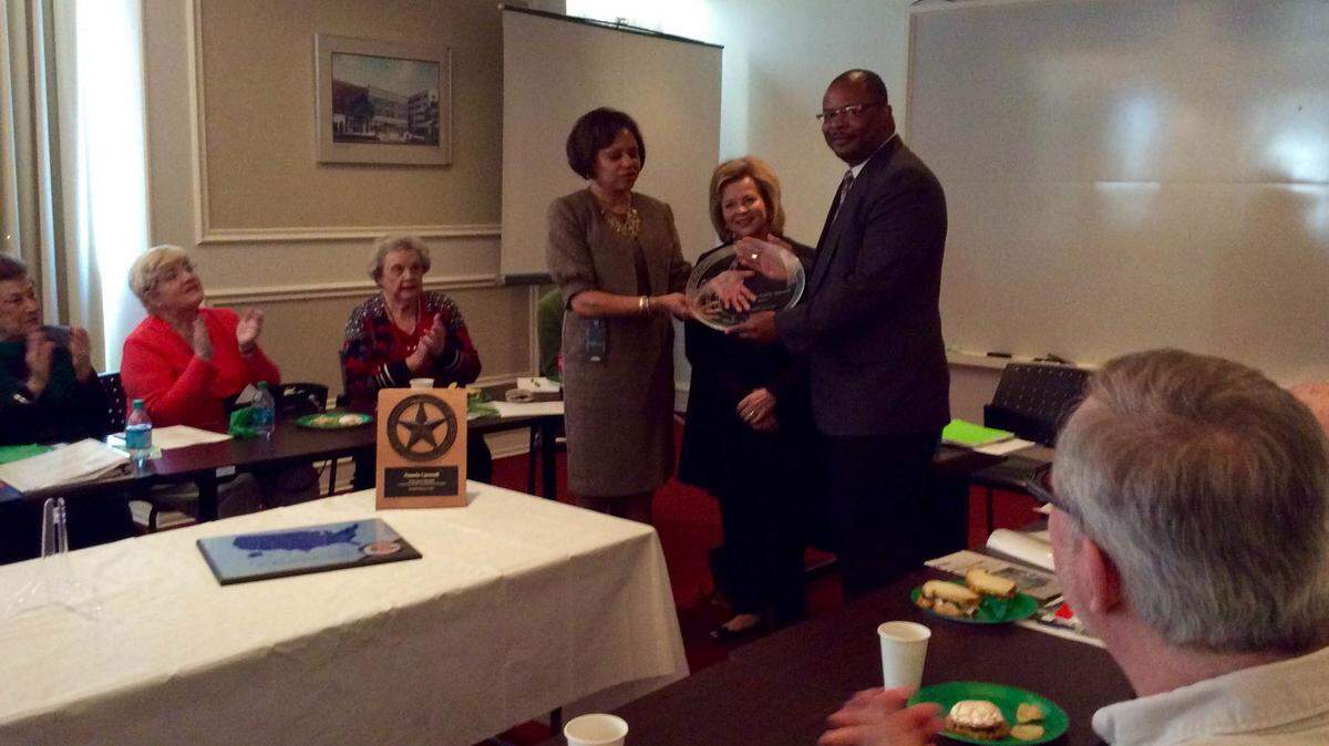 LIZ FABIAN/THE TELEGRAPH 
 The Keep Macon-Bibb Beautiful Commission celebrated Frank Austin's Iron Eyes Cody Award during their meeting Thursday at Terminal Station. Board chairwoman Theresa Robinson, center, recognized Austin, right and CEO Pam Carswell, who also won a Keep Georgia Beautiful Lynn Cobb Award for her efforts as executive director.