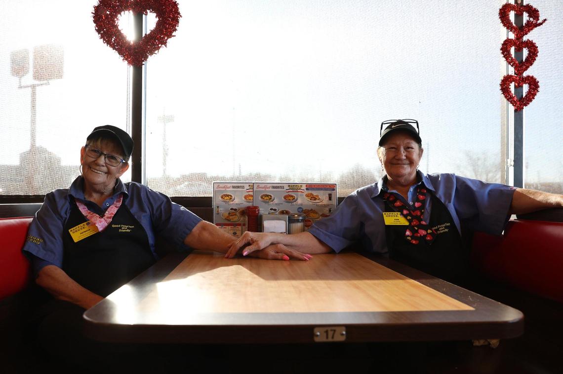 Twin sisters and longtime Waffle House employees Patricia “Pat” Miles (left) and Pam Campbell pose for a portrait in a booth at Waffle House on Sunday, Feb. 2, 2025, in Byron, Georgia. Miles and Campbell have worked at various Waffle Houses for around five decades, after starting as teenagers.