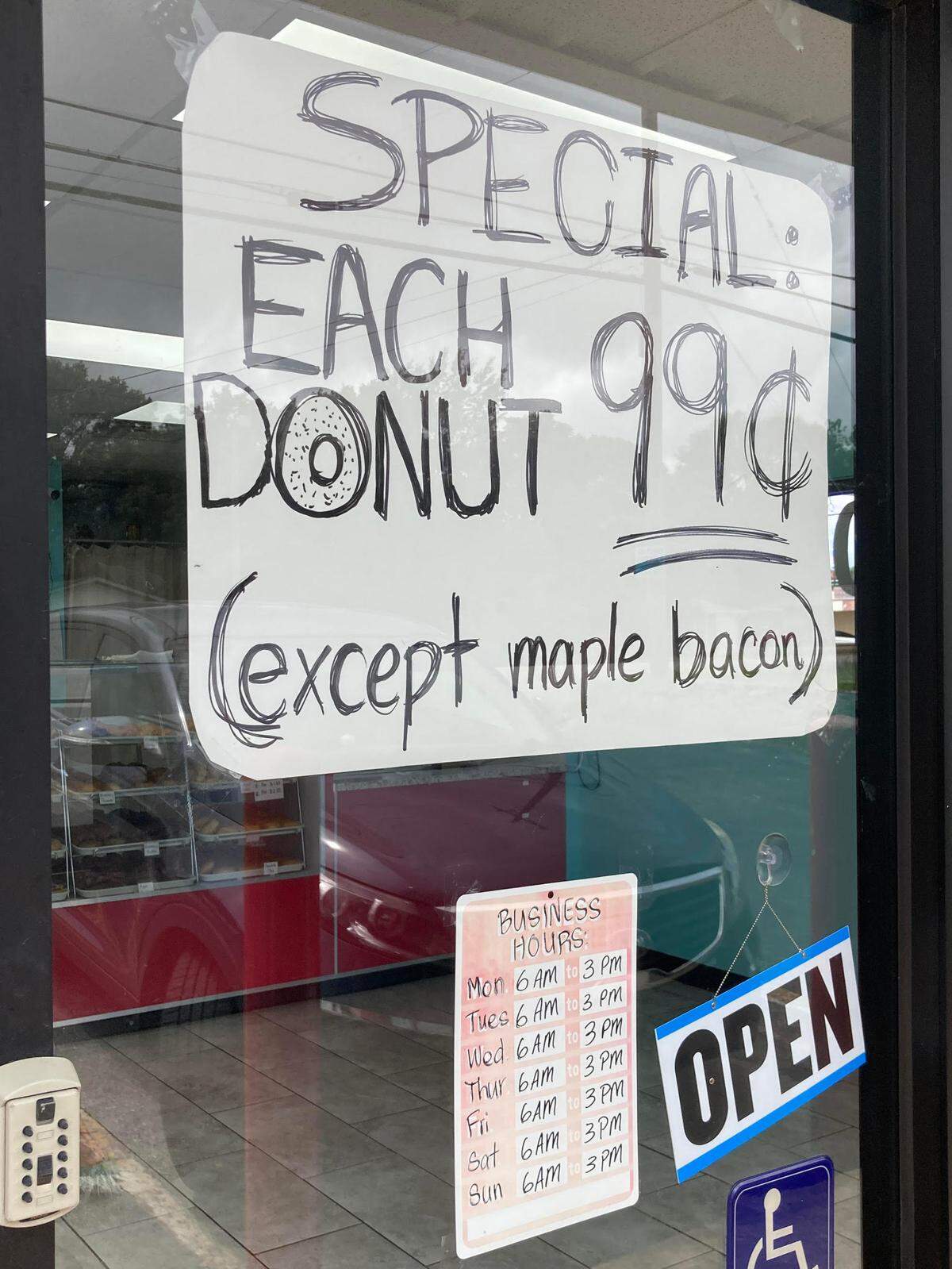 Sign in front door window at Ray’s Donuts in Warner Robins.