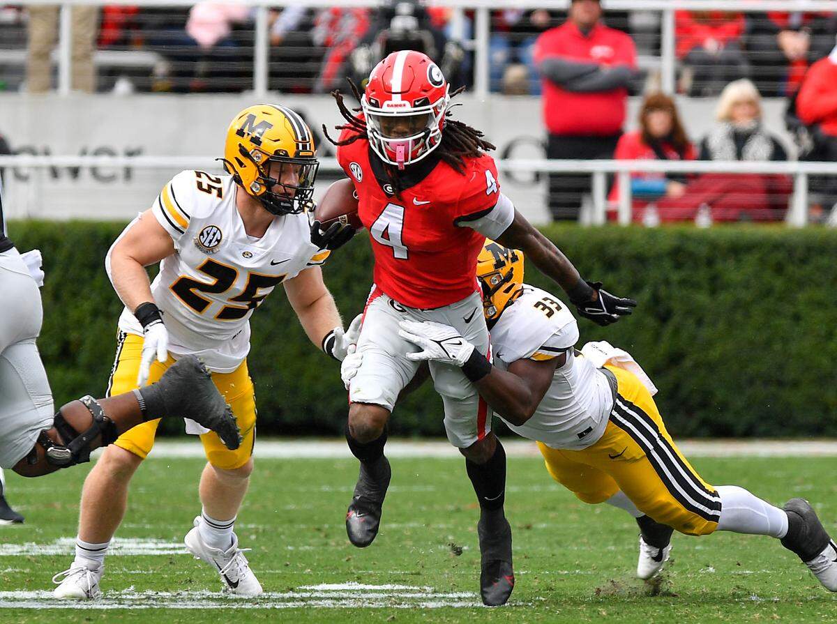 Georgia running back James Cook breaks a tackle and heads for a first down against Missouri.