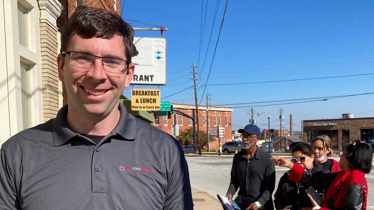 Josh Rogers, president and CEO of NewTown Macon, talks about the 2022 Tour of Progress while tour participants take a look at the Billingslea Commons development in the 800 block of Forsyth St. in downtown Macon.