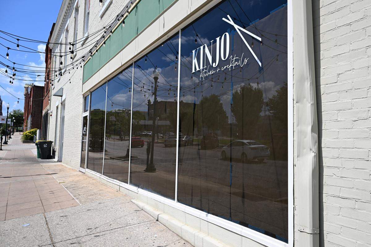 Brown paper lines the windows of Kinjo Kitchen + Cocktails on Monday, Aug. 18, 2025, in downtown Macon, Georgia. The restaurant announced on Monday that they were closed effective immediately. 