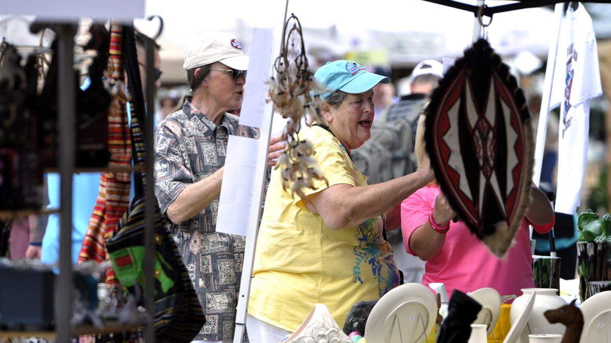 WOODY MARSHALL/THE TELEGRAPHHelen Collins shops at one of the vendor tents at a previous year's Dogwood Festival in Perry.