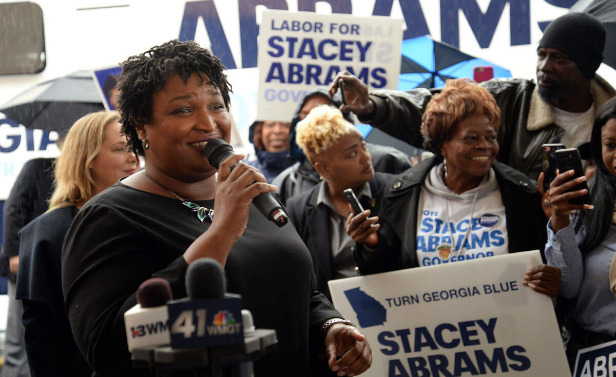 Georgia gubernatorial candidate Stacey Abrams speaks to a crowd of supporters shortly before Election Day at the Westgate Mall Shopping Center next to the Bibb County Elections Board office as part of her Early Voting Bus Tour.