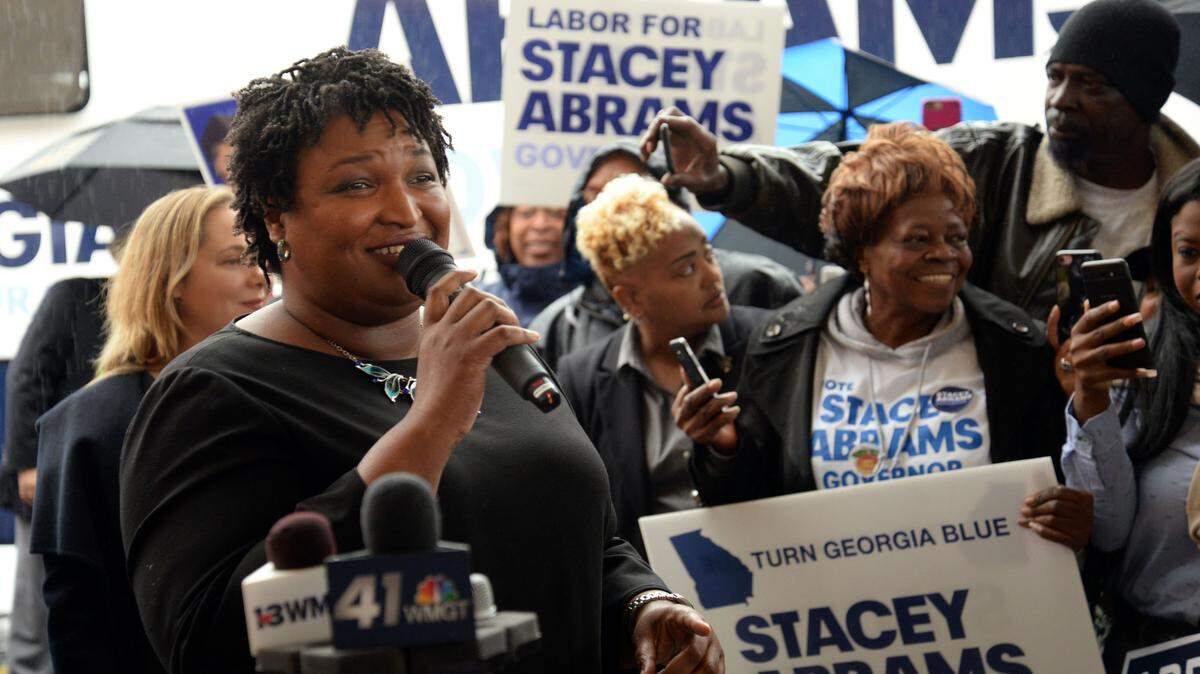 Georgia gubernatorial candidate Stacey Abrams speaks to a crowd of supporters shortly before Election Day at the Westgate Mall Shopping Center next to the Bibb County Elections Board office as part of her Early Voting Bus Tour.