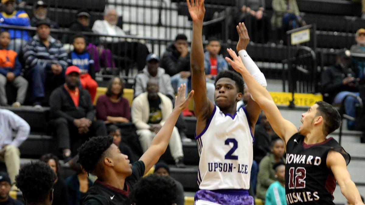 Upson-Lee’s Jarrett Adderton (2), middle, shoots with Howard’s Tyus Lunce (12) defending in the region 2-AAAA championship on Friday at Mary Persons High School.