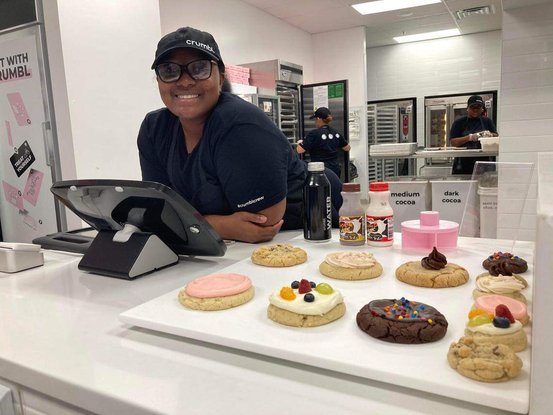 Erica McCoy works the register at the opening of Crumbl Cookies in Warner Robins.
